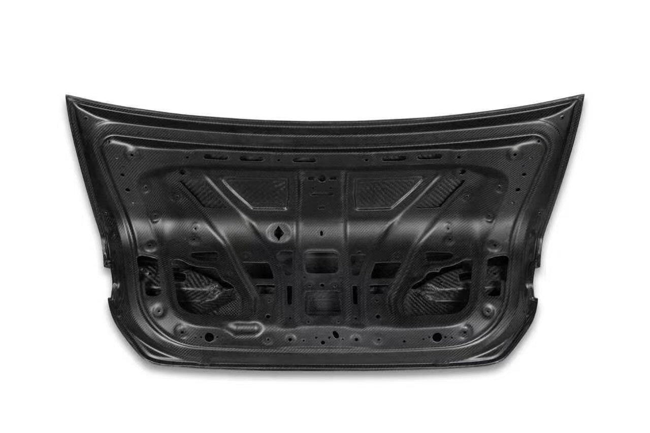 Black car trunk lid replacement part for BMW 5 Series G60/G68, shown from the underside on a white background.